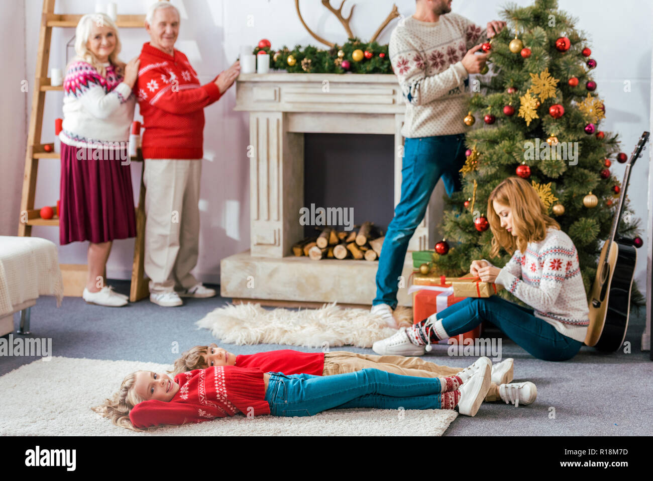 happy family decorating living room for christmas together Stock Photo ...