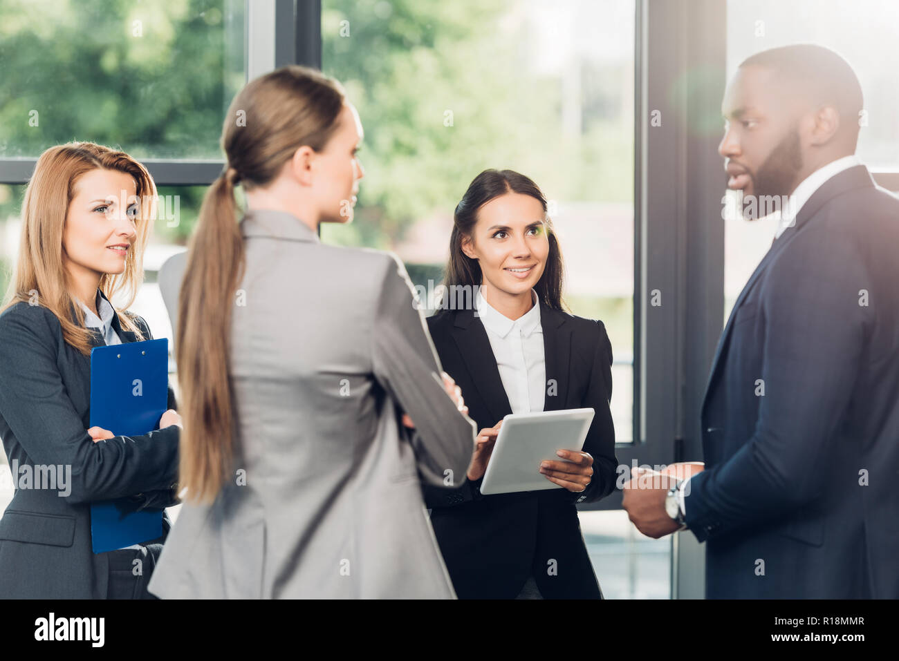multiethnic business colleagues having conversation in office Stock Photo