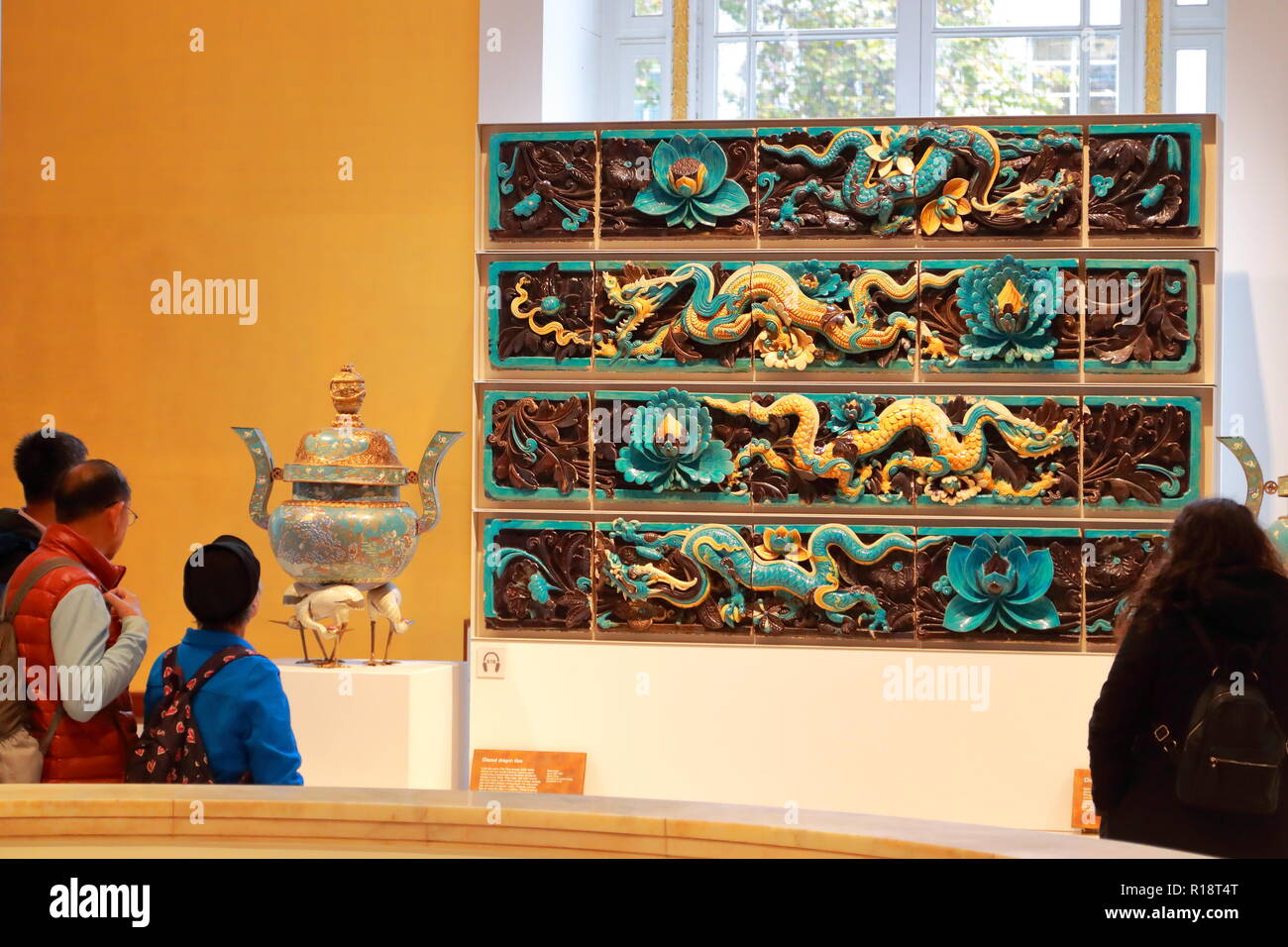 Visitors admire Chinese glazed dragon tiles at the British Museum