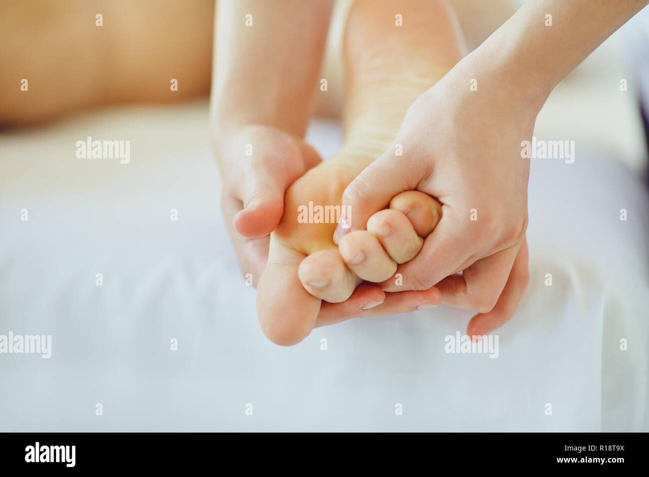 Foot massage for man in massage salon. Stock Photo