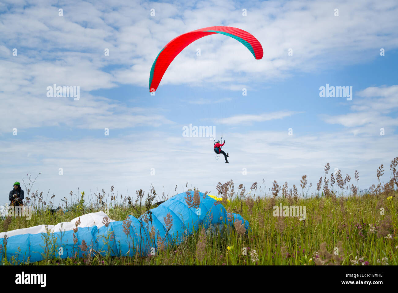 Paragliding in dynamic wind along the dunes in the beach Stock Photo