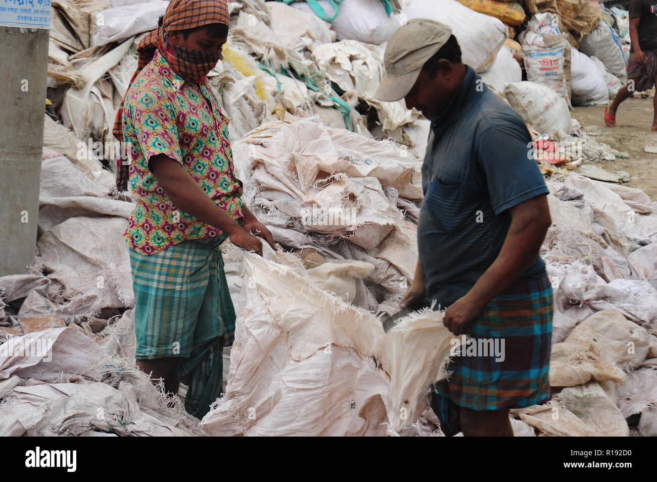Bangladeshi workers dries reject plastic bag in Nararyanganj