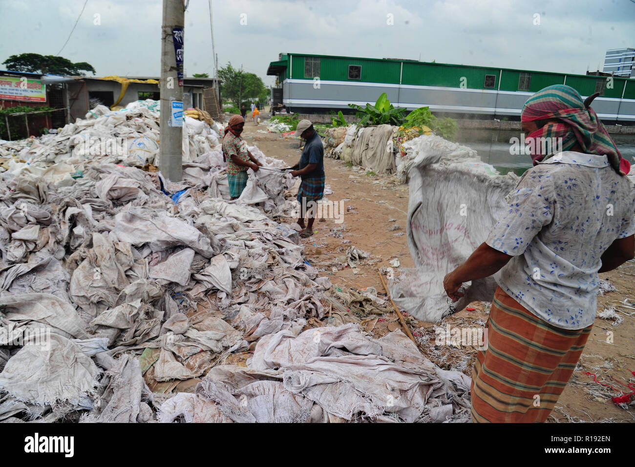 Bangladeshi workers dries reject plastic bag in Nararyanganj