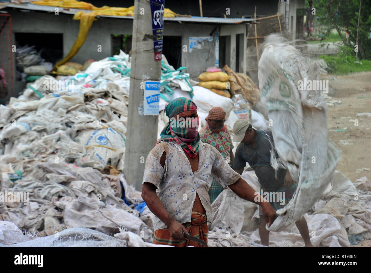 Bangladeshi workers dries reject plastic bag in Nararyanganj
