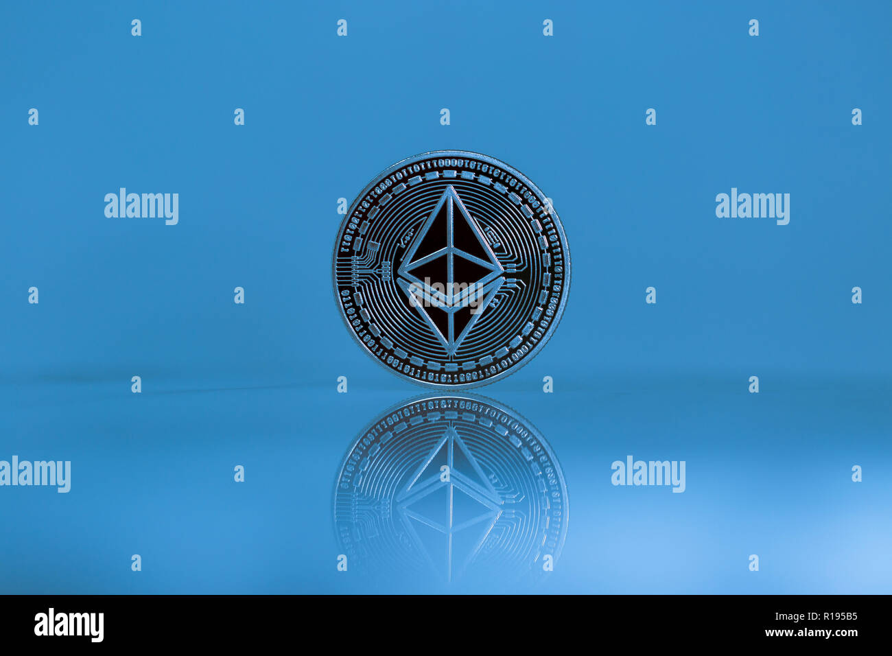 Ethereum Classic physical coin in the blue background Stock Photo