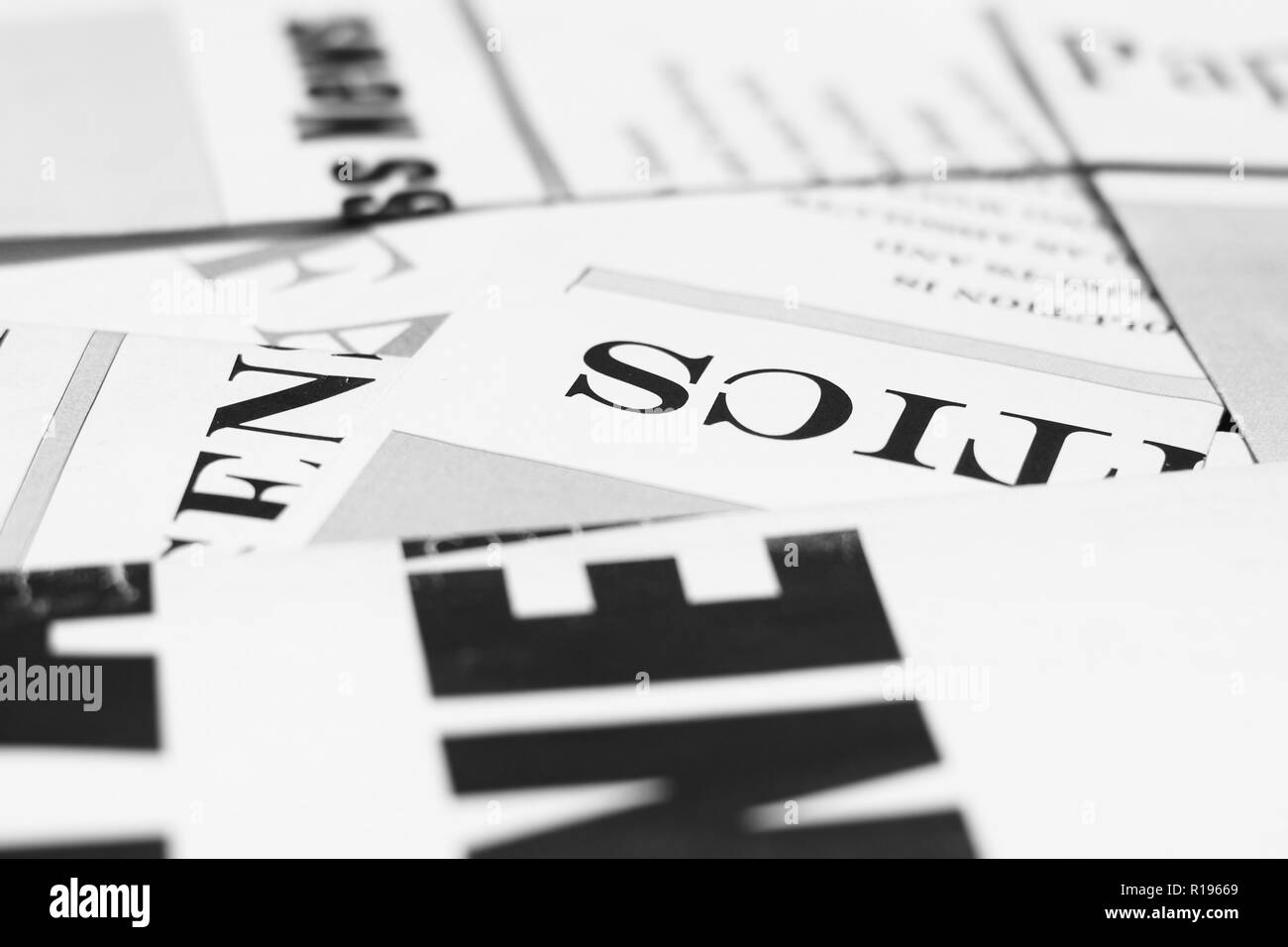 Business news on pages of journals and magazines. Newspapers with headlines and articles scattered on horizontal surface, side view background texture Stock Photo