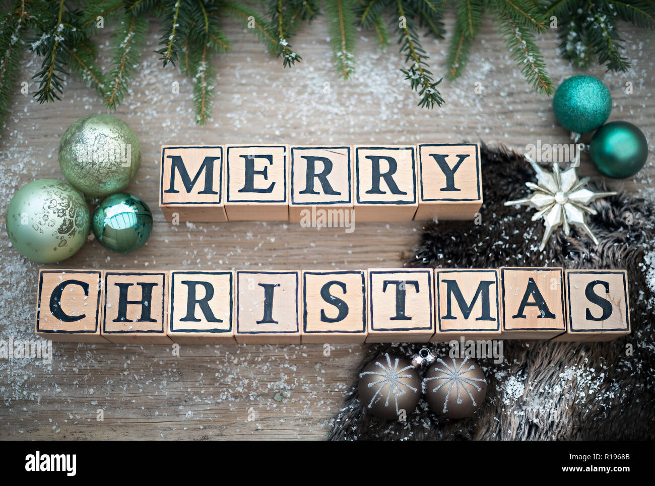 Wooden Cubes With Letters Form The English Text Merry Christmas They Are Lying On A Wood Background Fir Branches And Christmas Balls Are Next To It Stock Photo Alamy