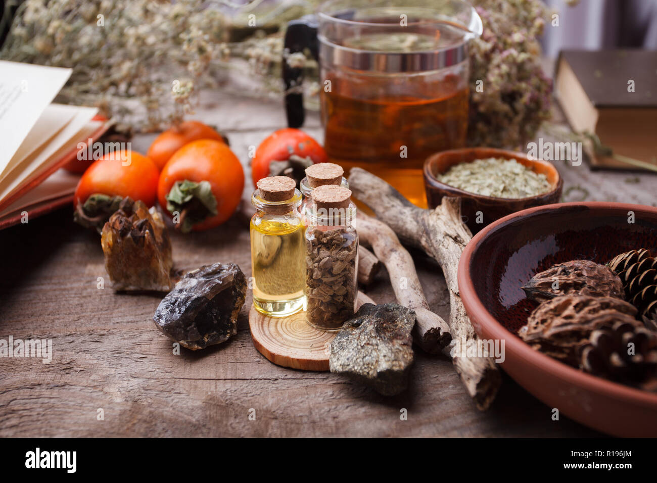 Authentic interior details, glass of herbal rea, dry herbal plants, homeopathic treatment on rustic wooden background, alternative medicine, healthy c Stock Photo