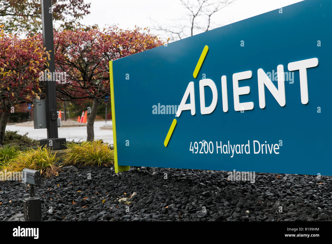 A logo sign outside of a facility occupied by Adient in Plymouth ...