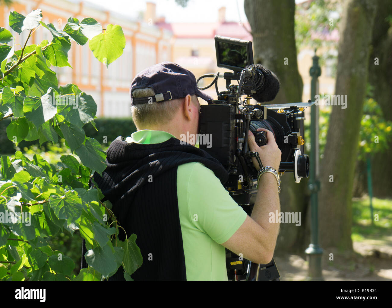 Journalist shooting with professional TV camera. Stock Photo