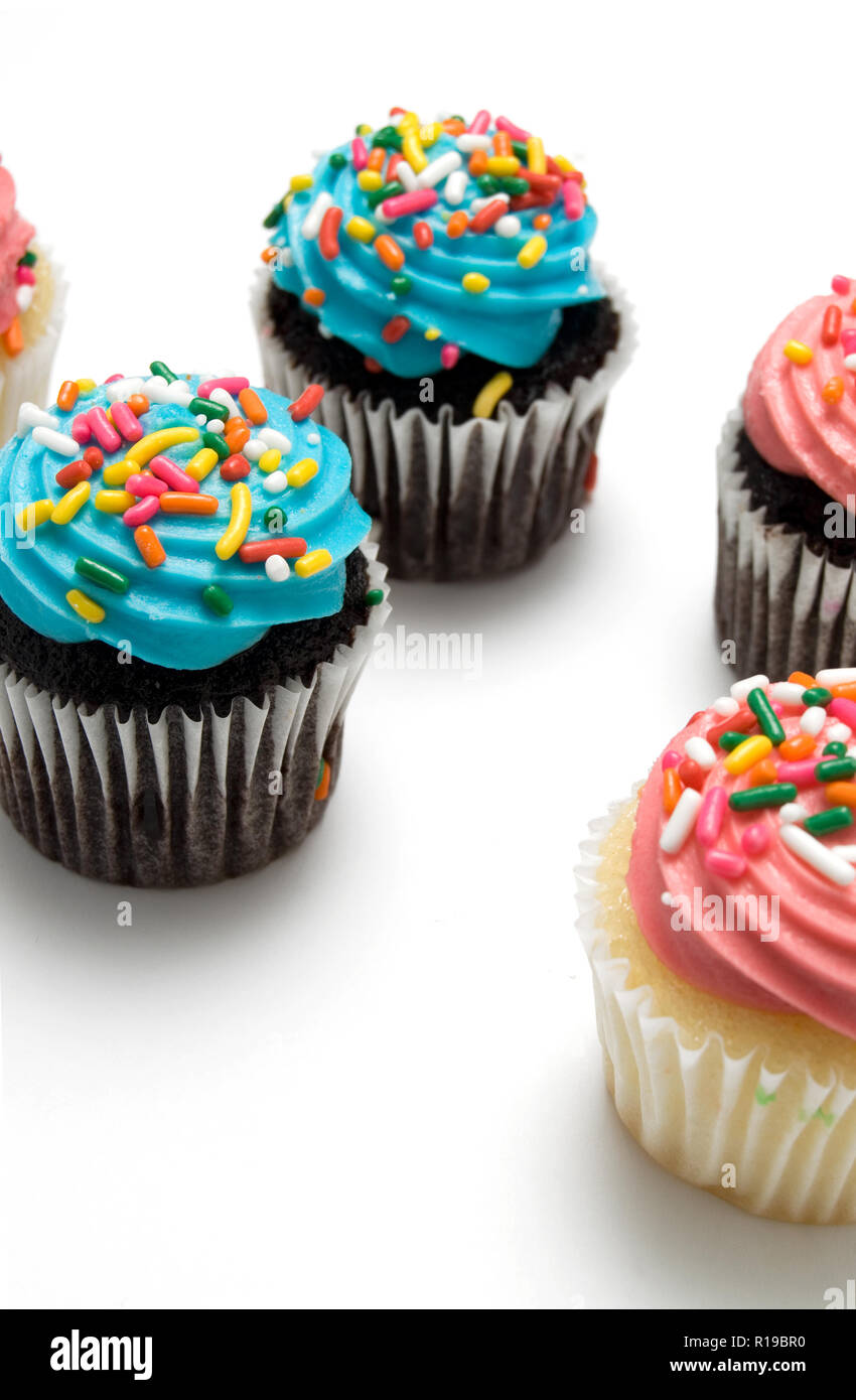 Blue and Pink Muffins with Colored Sprinkles on White Background Stock ...