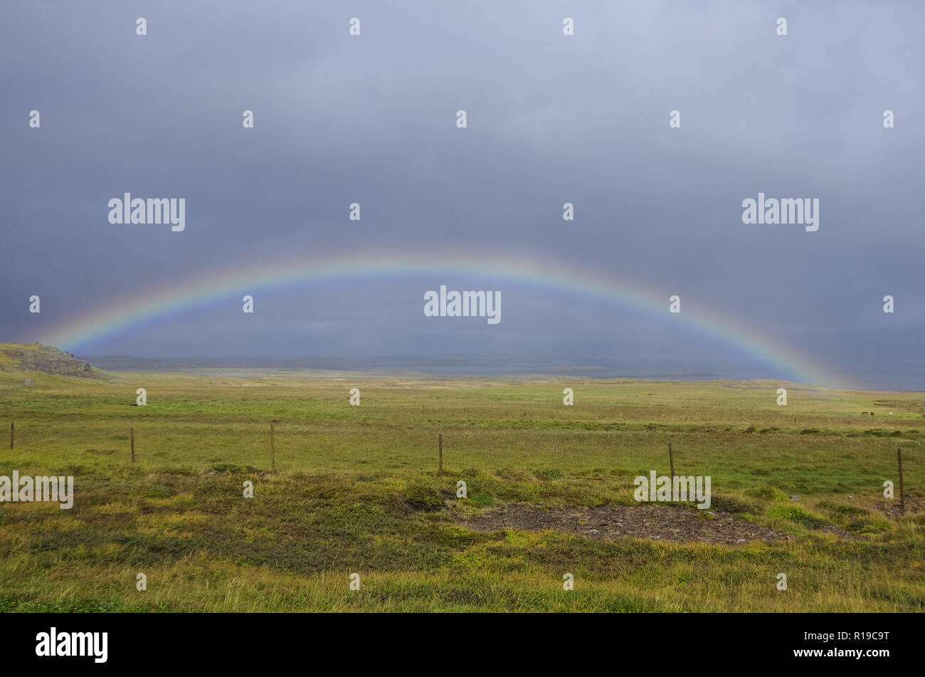 Rainbow over meadow in Snaefellsnes peninsula, Iceland Stock Photo