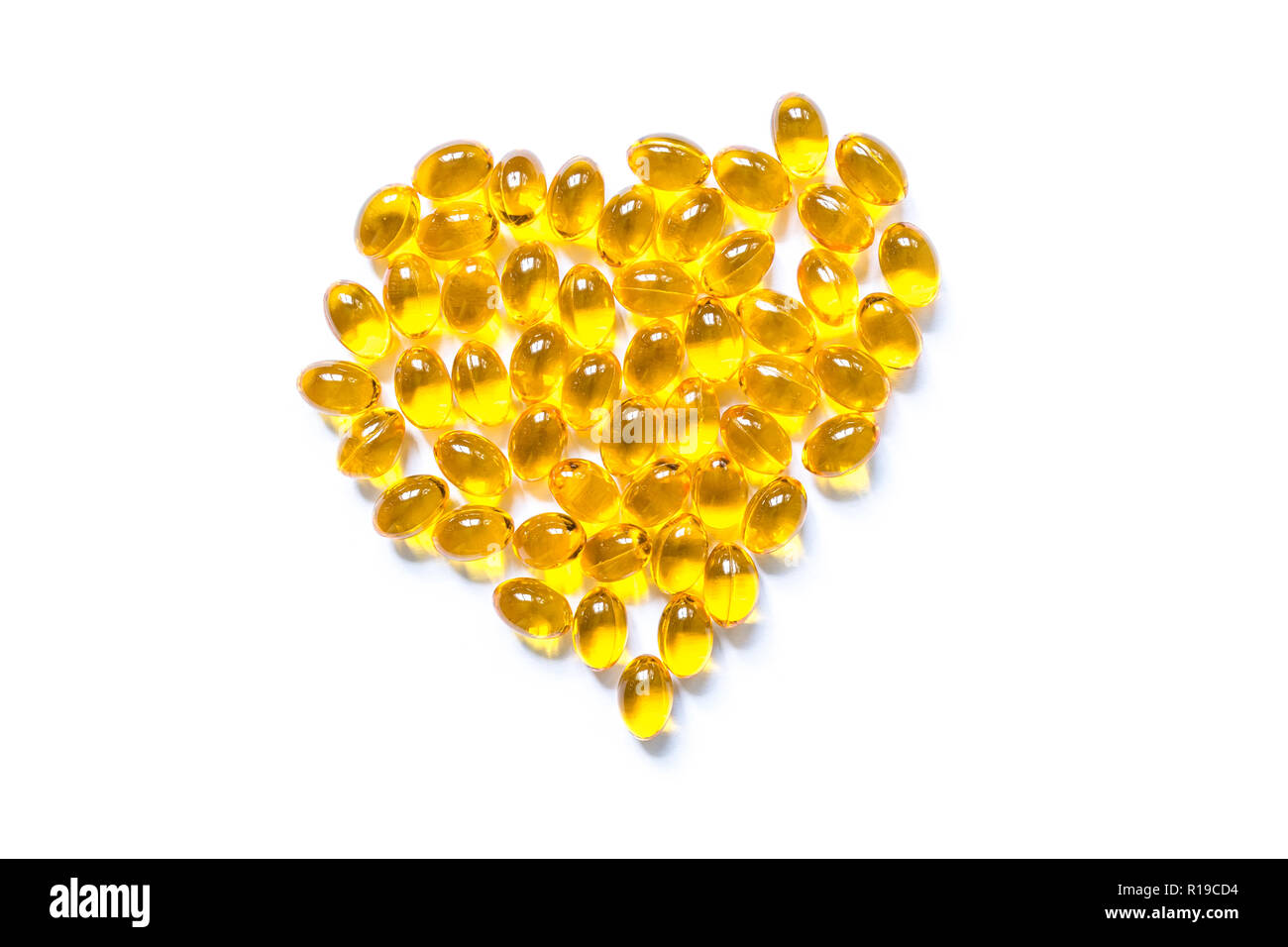 Download Fish Oil Capsule Pills Of Yellow Color In The Shape Of A Heart Closeup Isolated On White Background Stock Photo Alamy Yellowimages Mockups