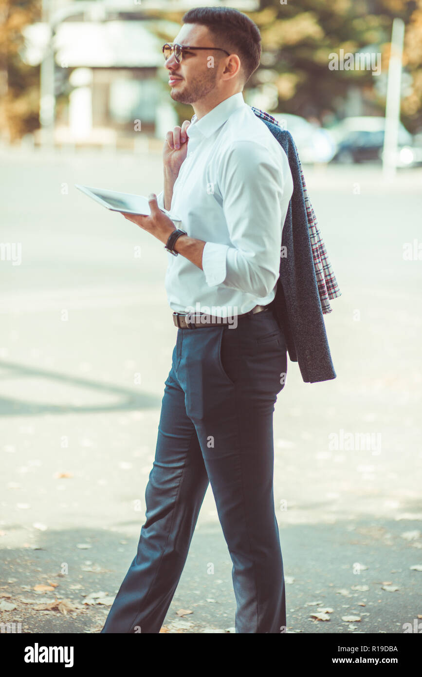 Stylish businessman in suit on sunny city street hi-res stock ...