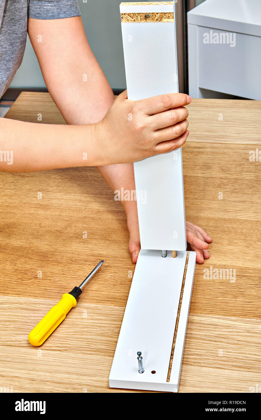 The handyman joins together the two parts of the readytoassemble