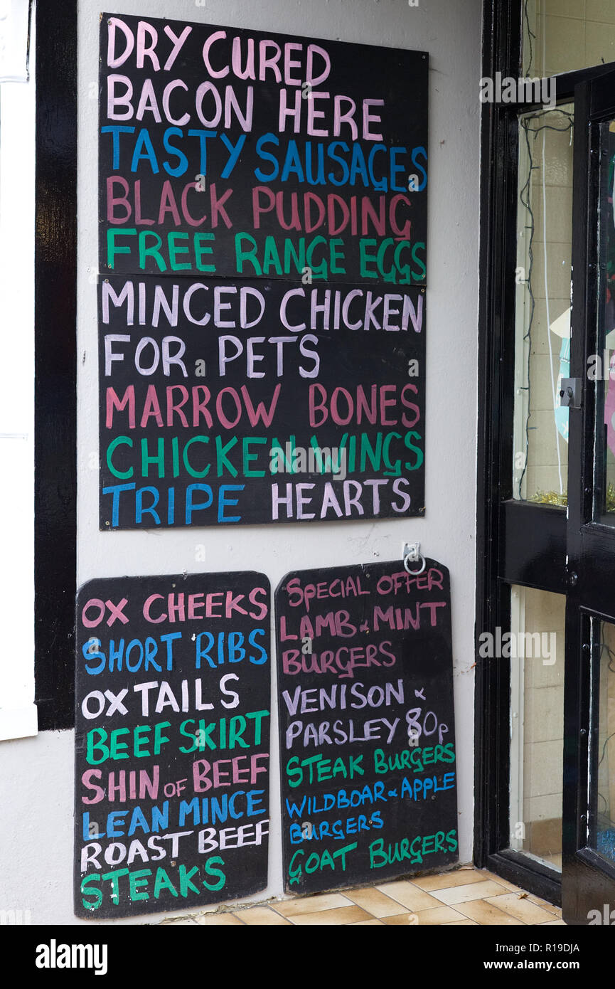 colourful blackboard at a butchers advertising meats Stock Photo