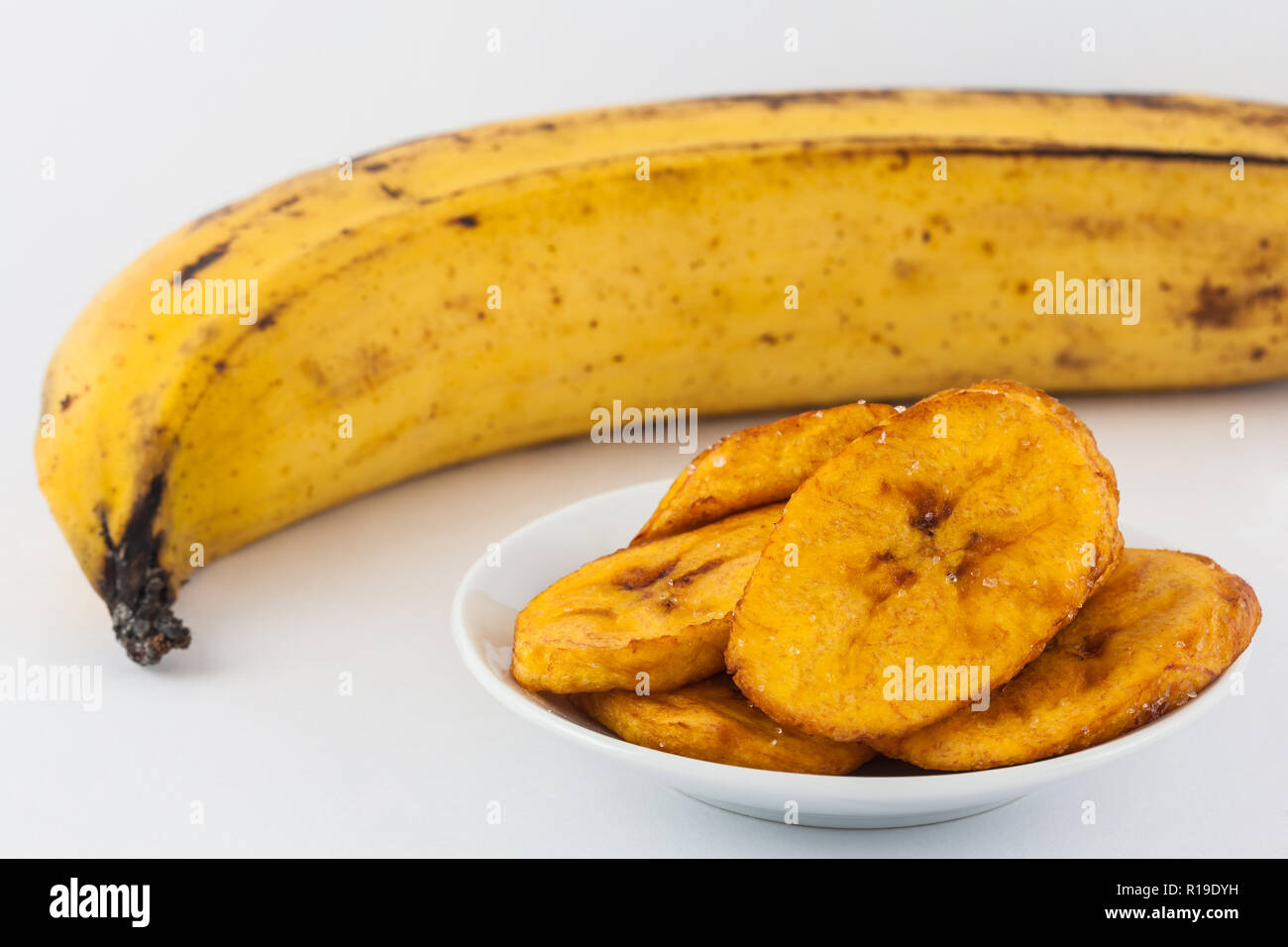 Fried half ripe plantain slices isolated on white background Stock ...