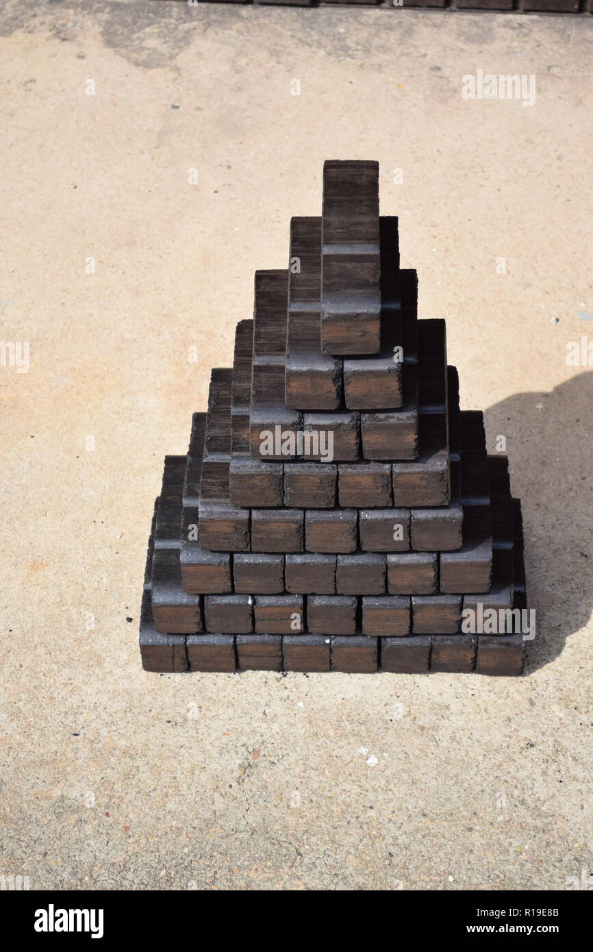 tower of lignite briquettes with two single bricks in front, white  background, isolated, copy space Stock Photo - Alamy