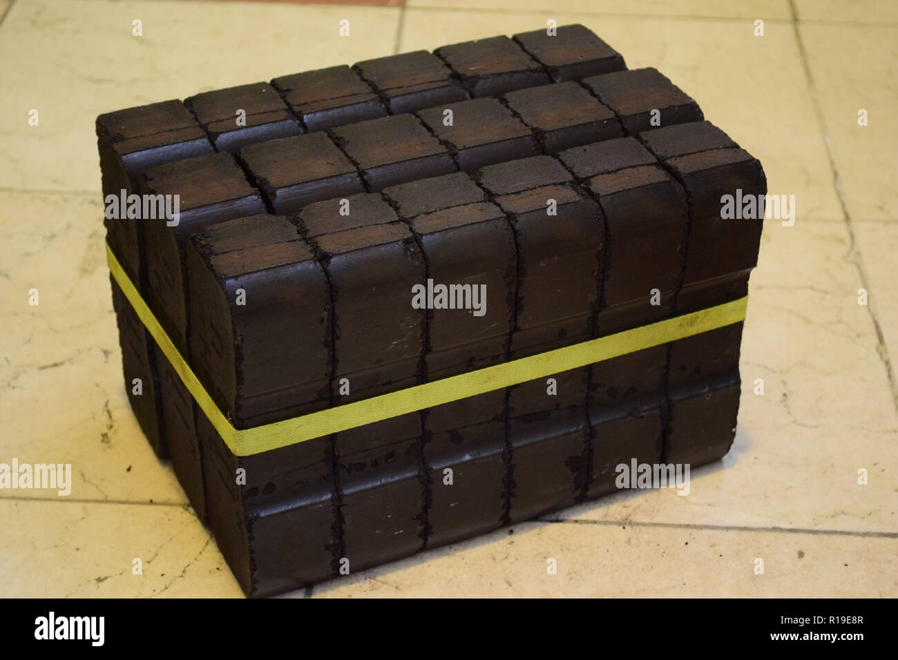 Brown coal briquette stockpile as an alternate heating source for fireplace or even for an solid fuel oven heating the whole house. Stock Photo