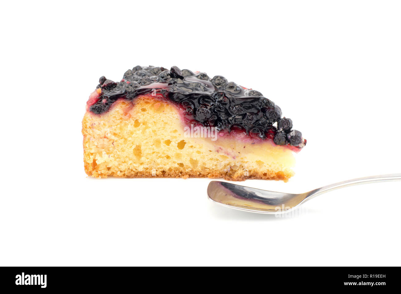 a piece of blueberry pie with a spoon isolated on a white background Stock Photo