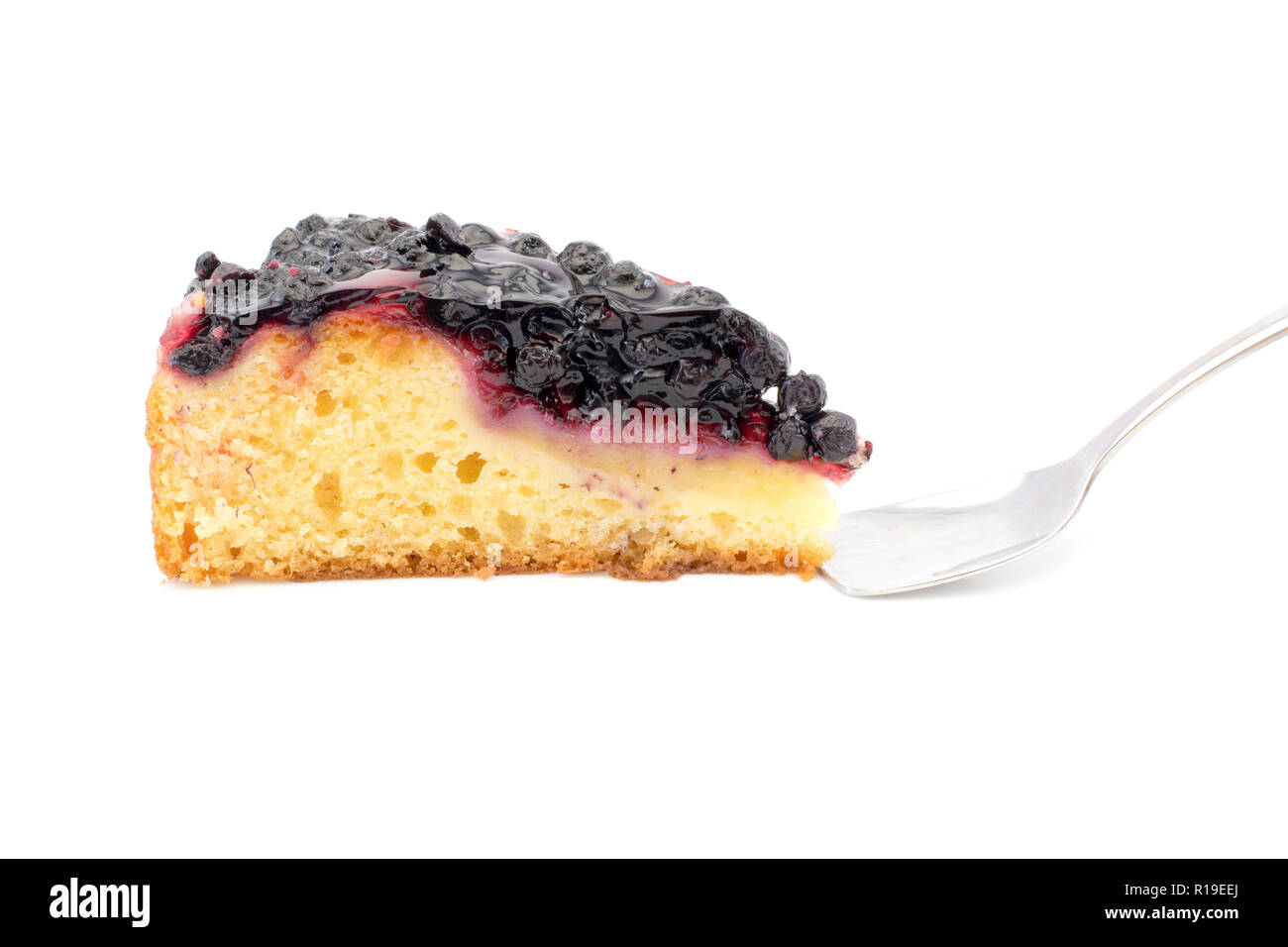 a piece of blueberry pie with a spoon isolated on a white background Stock Photo