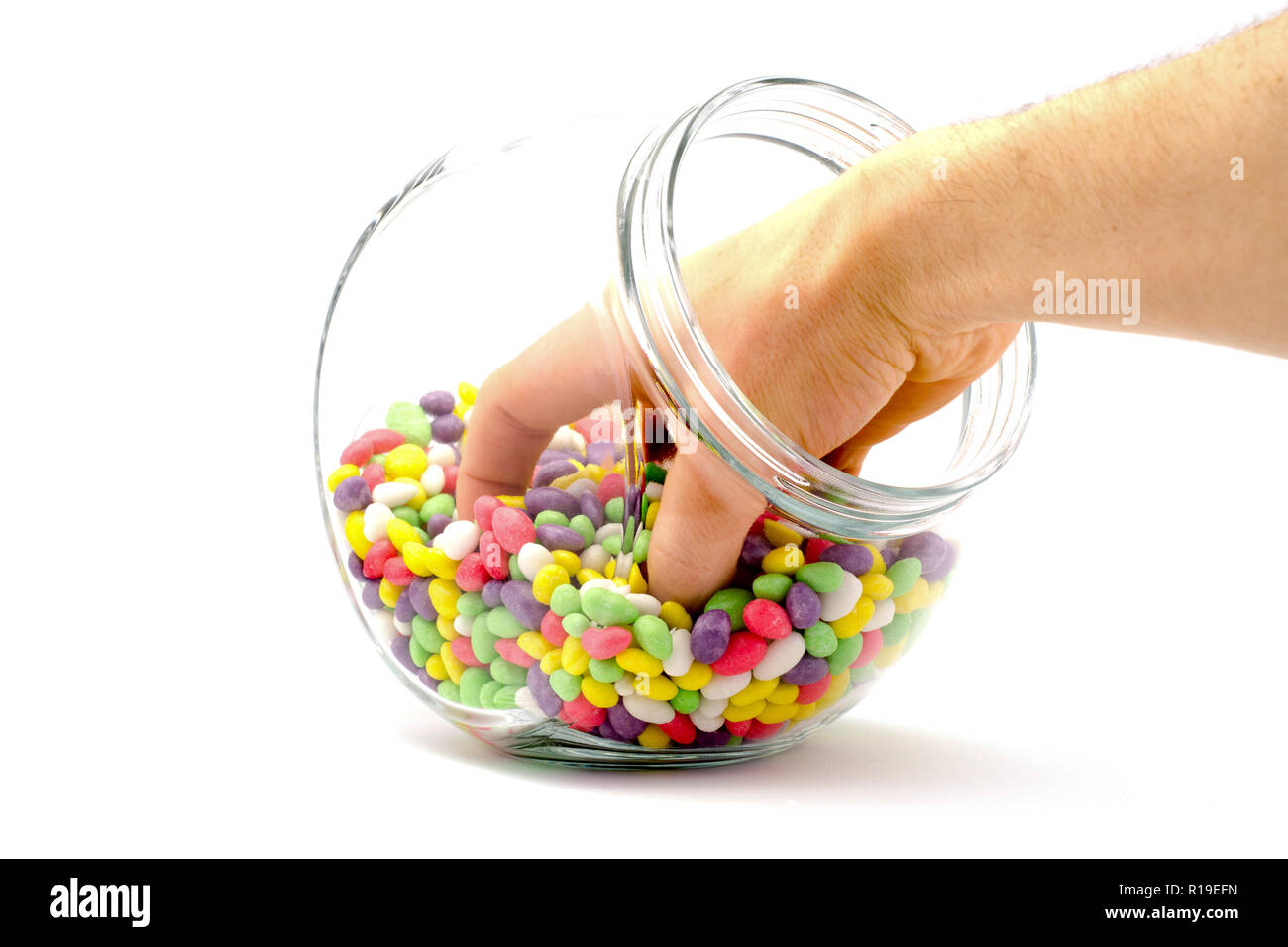 Candy Bucket Hand hand in a jar with colored candies on a white background Stock Photo ...