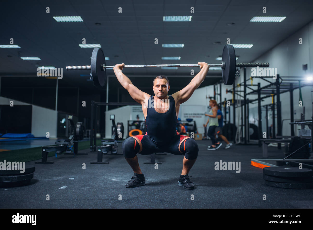 Strong male powerlifter doing deadlift a barbell in gym. Weightlifting ...