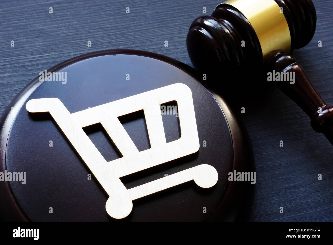 Consumer rights. Shopping cart and gavel. Stock Photo