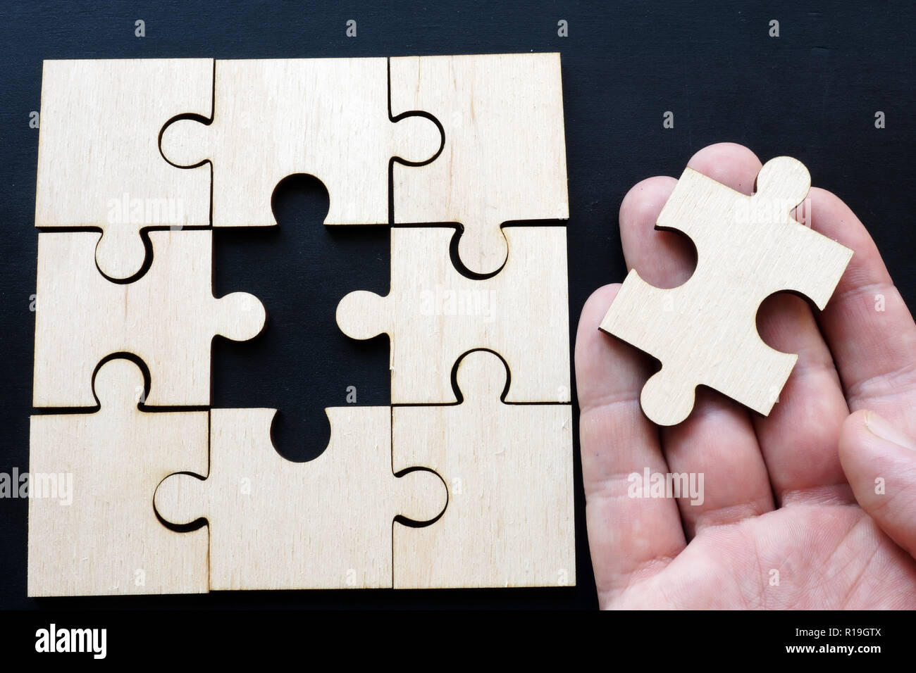 Man holding piece of puzzle. Solution problem with business. Stock Photo