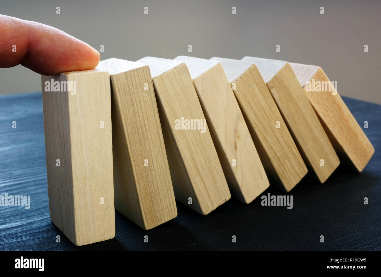 Hand support falling blocks with domino effect. Problem solving skills. Stock Photo