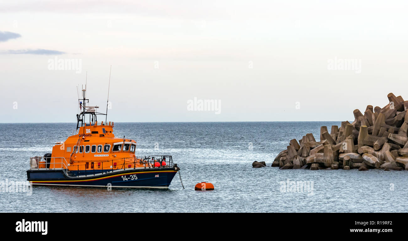 Torness, East Lothian, Scotland, United Kingdom, 10th November 2018. UK Weather: Despite the storm on the UK's West coastline, Eastern Scotland is mild with only a slight breeze. The Dunbar RNLI lifeboat John Neville Taylor at its low tide mooring next to Torness nuclear power station Stock Photo