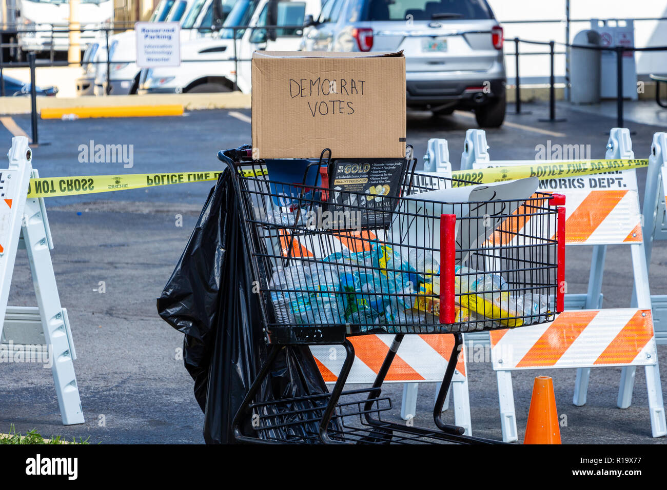 Lauderhill, Florida, USA. 10th Nov, 2018. A homemade cardboard box with 'Democrat Votes' written on the side sits atop a shopping cart filled with garbage. The cart was part of a vote counting protest outside Broward County Supervisor of Elections Brenda Snipes' office. The protest began over controversy surrounding the results of the 2018 midterm elections for Florida Governor and Florida Senator. Holly Guerrio/Alamy Live News Stock Photo
