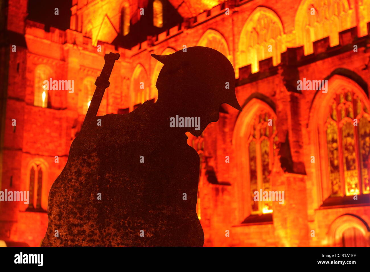 Ripon, North Yorkshire. 10th November2018. Soldier silhouettes placed opposite Ripon Cathedral to mark armistice day 2018. The Cathedral was also lit up in red around the back and sides, while the front was lit by animated projection. Credit: Yorkshire Pics/Alamy Live News Stock Photo