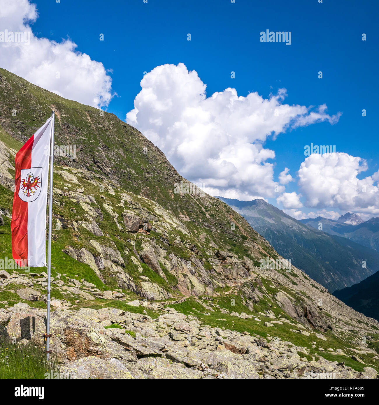 Tyrolean flag on a hiking trail at an alpine hut in Stubai Valley, Innsbruck, Tyrol, Austria Stock Photo
