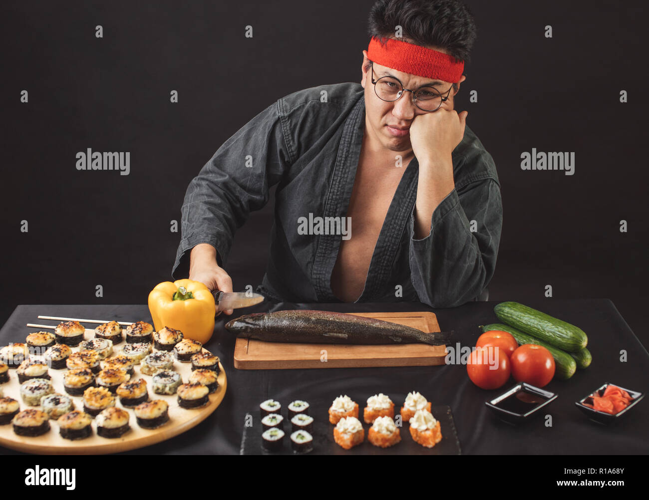 unhappy young Asian man in the kitchen Stock Photo