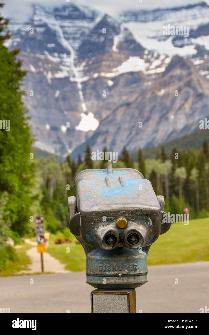 MOUNT ROBSON, BRITISH COLUMBIA, CANADA - JUNE 2018: Binocular viewing device for tourists with Mount Robson in the background. Stock Photo