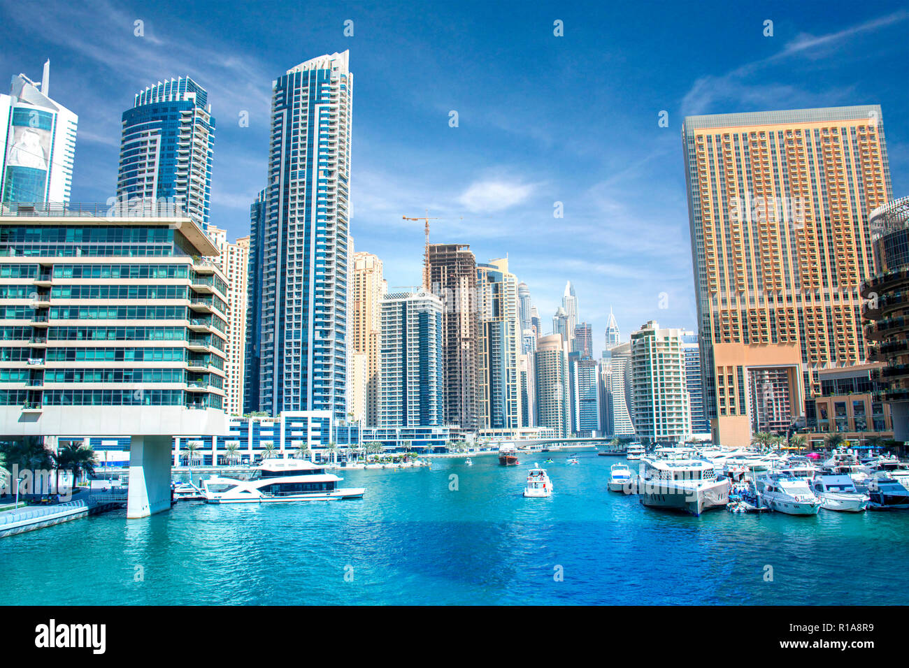 Beautiful View of Dubai Marina lake with luxury superyacht and colorful buildings Stock Photo