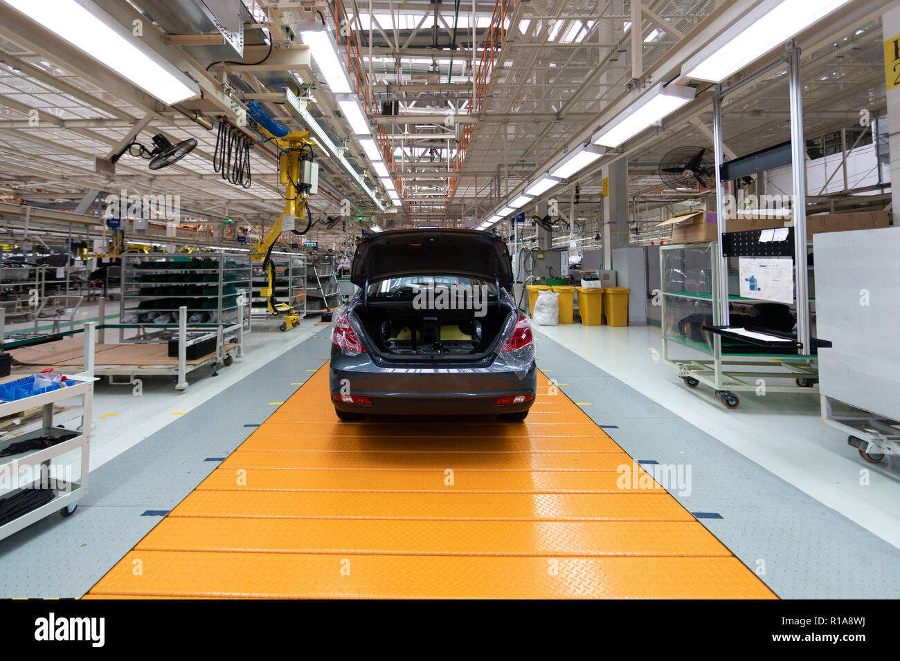 Assembled car is on the Assembly line. Robotic equipment makes the Assembly of the car. Modern car Assembly at the factory Stock Photo