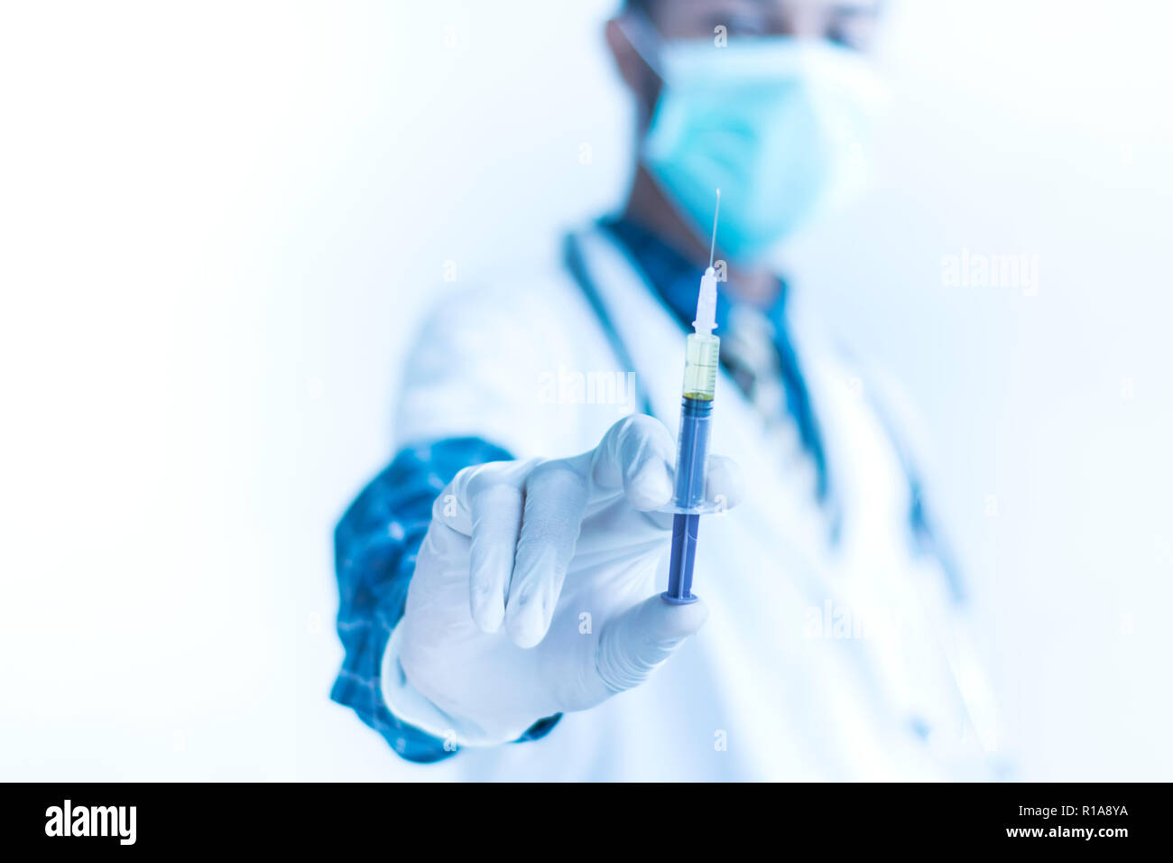 Doctor with Syringe ready to take injection healthcare concept image Stock Photo