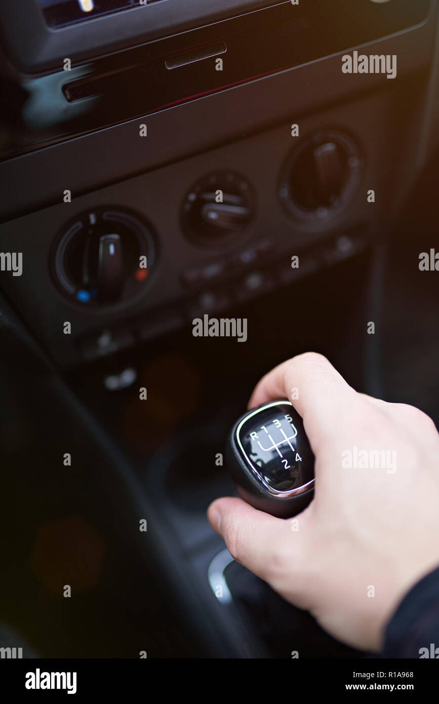 Hand on manual gear stick close up. Selecting gear on car Stock Photo