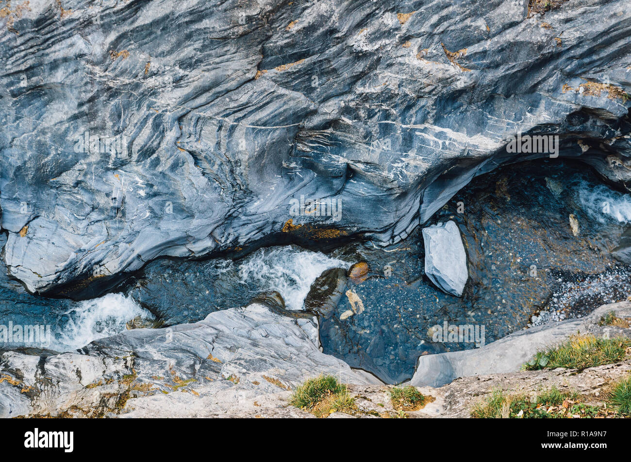 Water flowing down the Leukerbad themal springs gorge. Stock Photo