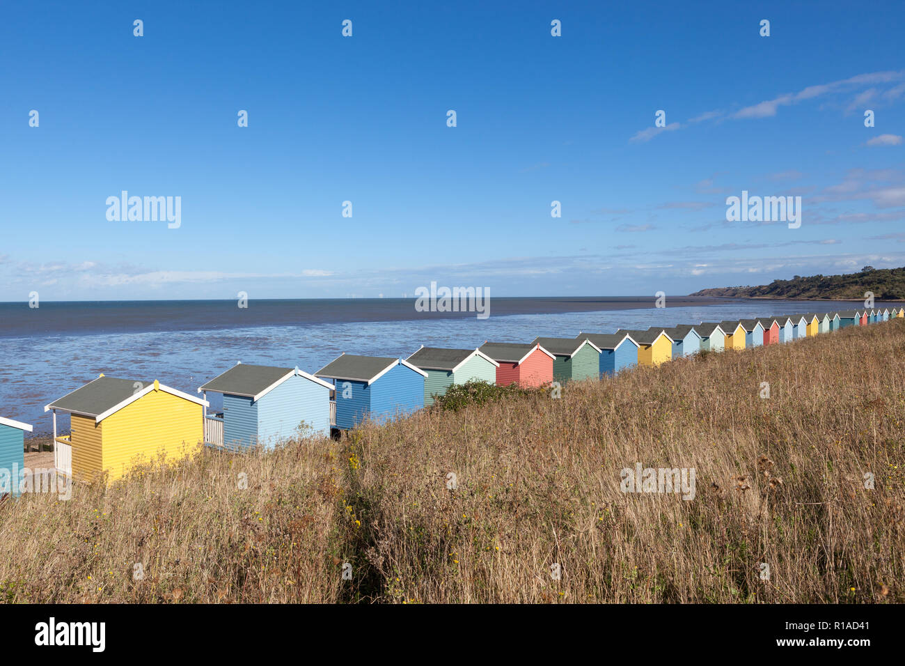 Row of colourful wooden beach huts. Stock Photo