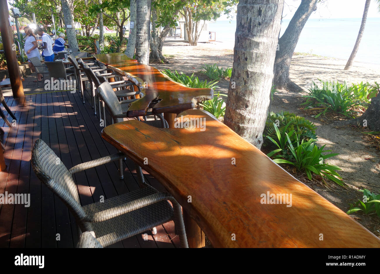 Cafe with timber table bar overlooking the beach, Holloways Beach, Cairns, Queensland, Australia. No PR or MR Stock Photo