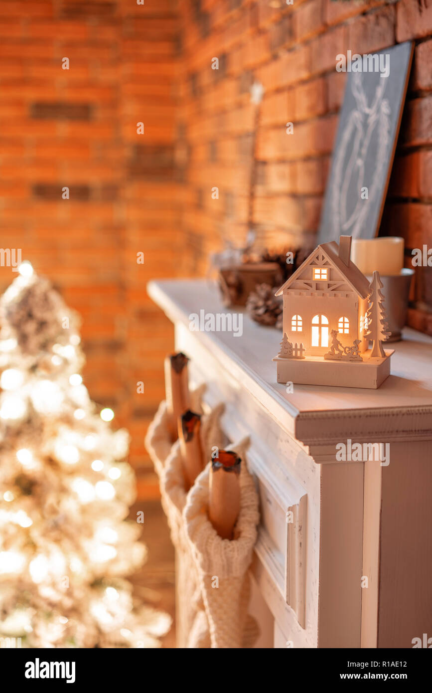 Small Wooden House With A Candle Inside White Wool Socks For