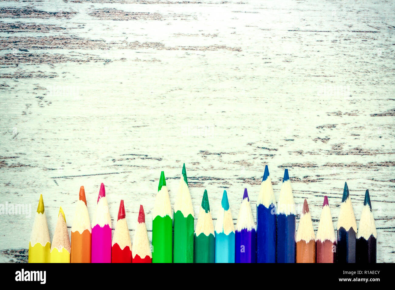 Colored multicolored pencils close up macro down on a vintage wooden background wooden worn Colored multicolored pencils close up macro down on a vintage wooden background wooden worn