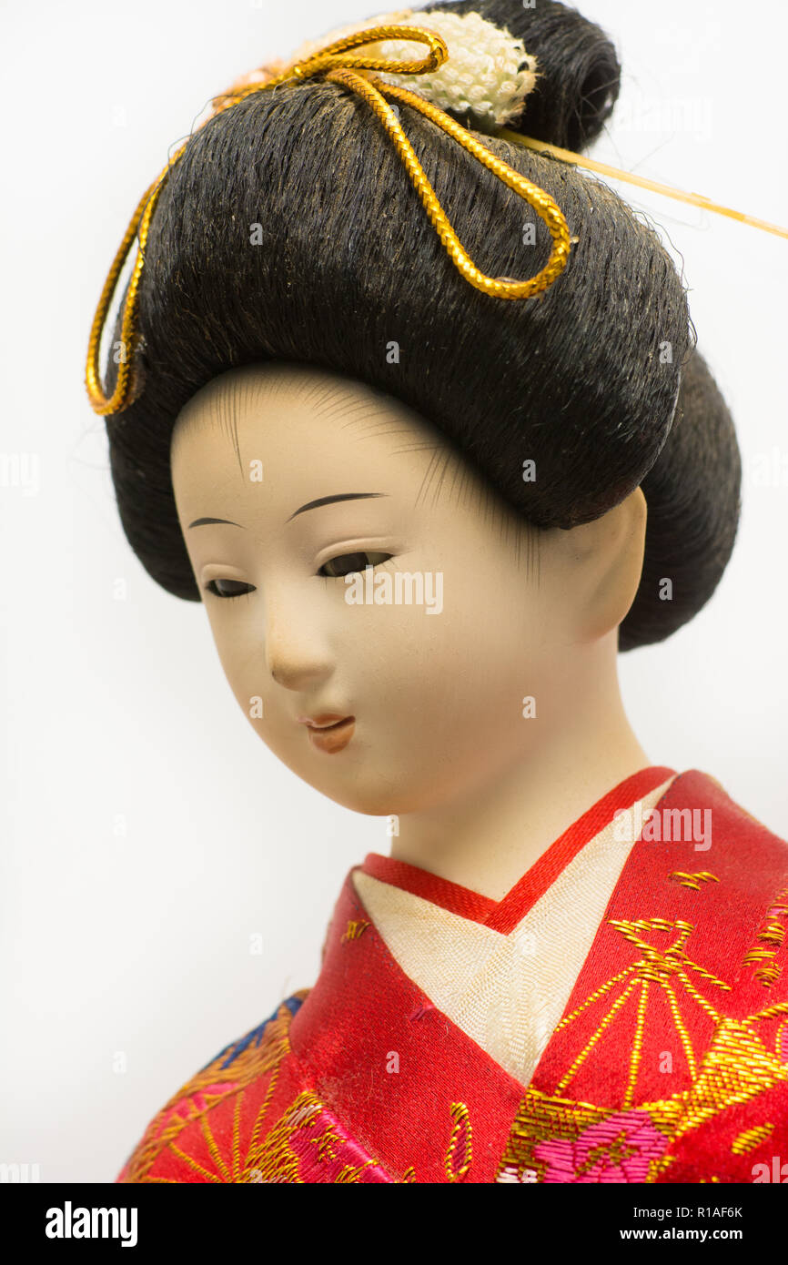 Japanese Geisha doll in red kimono isolated on white background Stock Photo