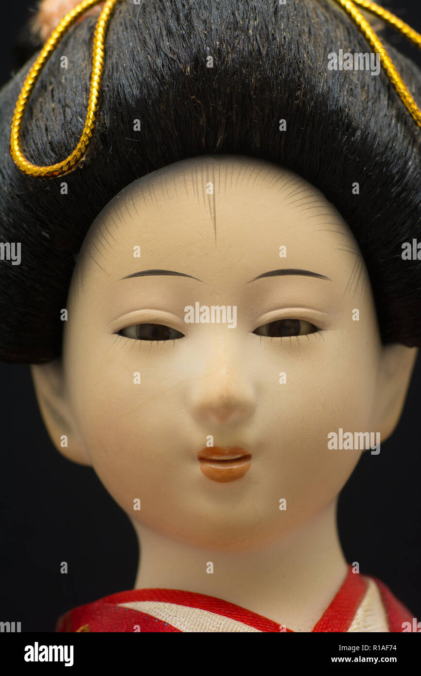A closeup of the face of a traditional Japanese Geisha doll Stock Photo