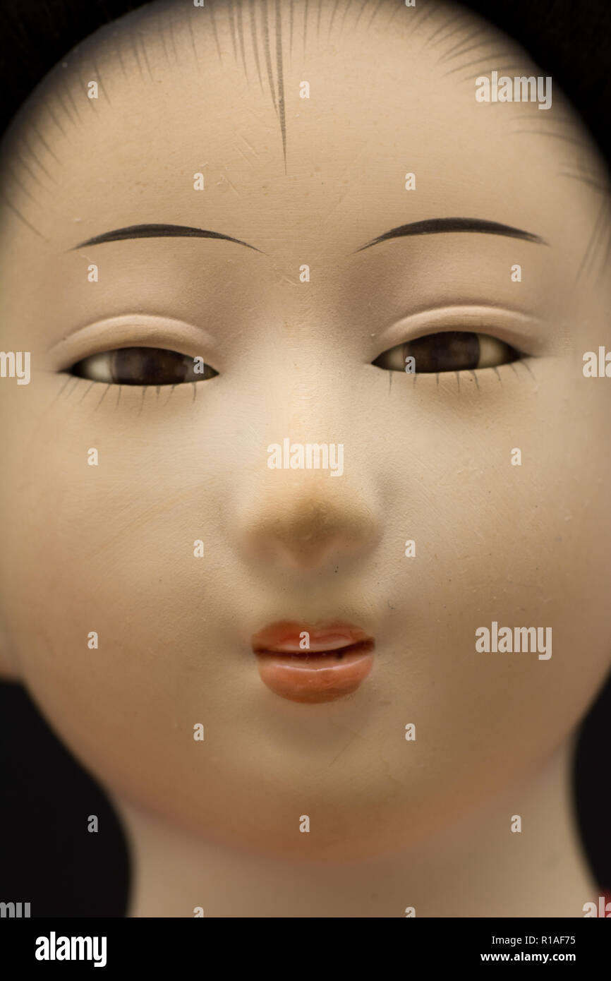 A closeup of the face of a traditional Japanese Geisha doll Stock Photo