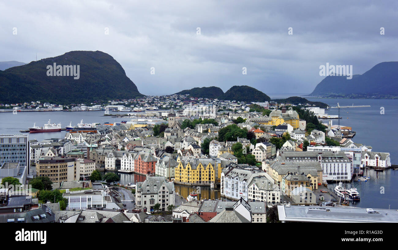 Aerial city view of Alesund from the top of Aksla mountain, Norway. Beautiful colorful houses on mountains background. Stock Photo