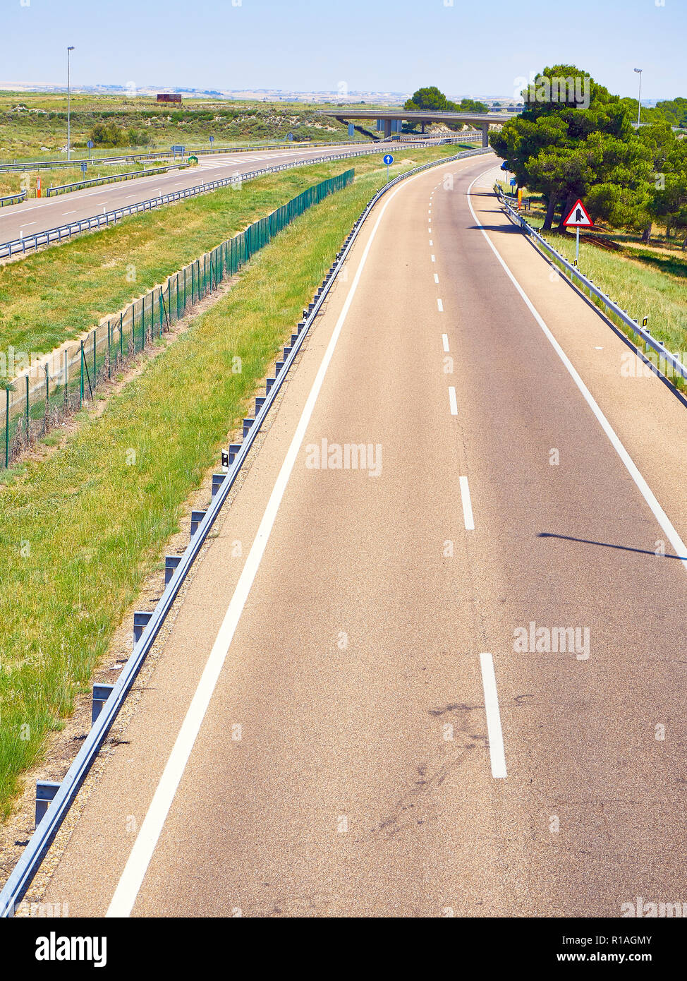 A european highway without traffic at a sunny day. Stock Photo